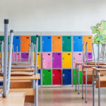 Classroom with colorful lockers and raised chairs on the tables